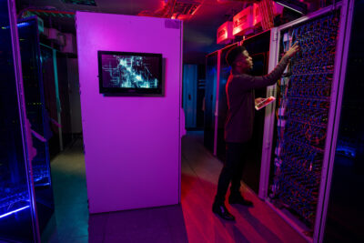 man monitoring server room and ensuring that disaster recovery plan is working