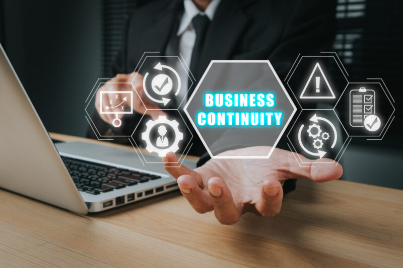 business continuity and disaster recovery, man's hand holding an image of business continuity