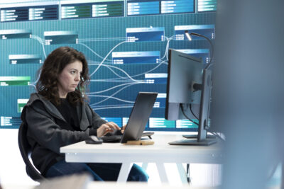 woman checking her laptop to examine data for hackers and working with cybersecurity 